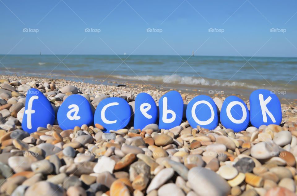 Facebook conceptual stones composition on the beach