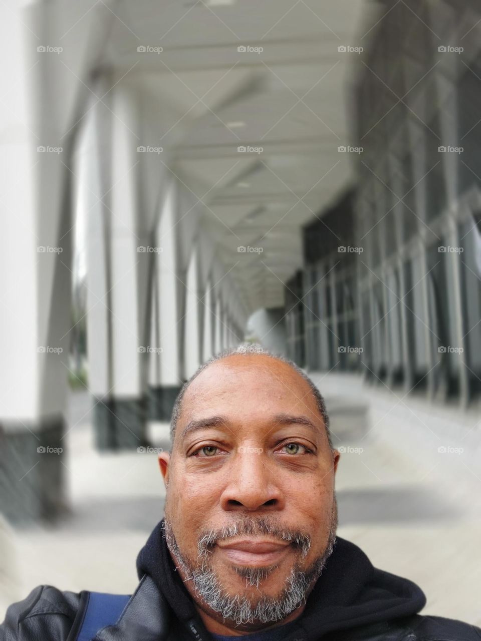 Self-portrait of a photographer with a architectural building in the background, in the downtown district of Sacramento California