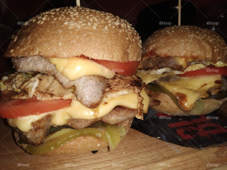 juicy homemade burgers with pickled cucumber, tomato, scrambled eggs with cheddar cheese and a delicious piece of meat