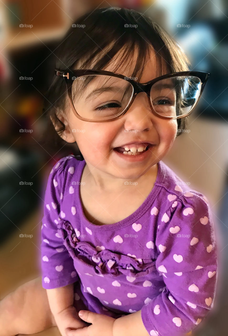 Baby girl smiling with big eyeglasses