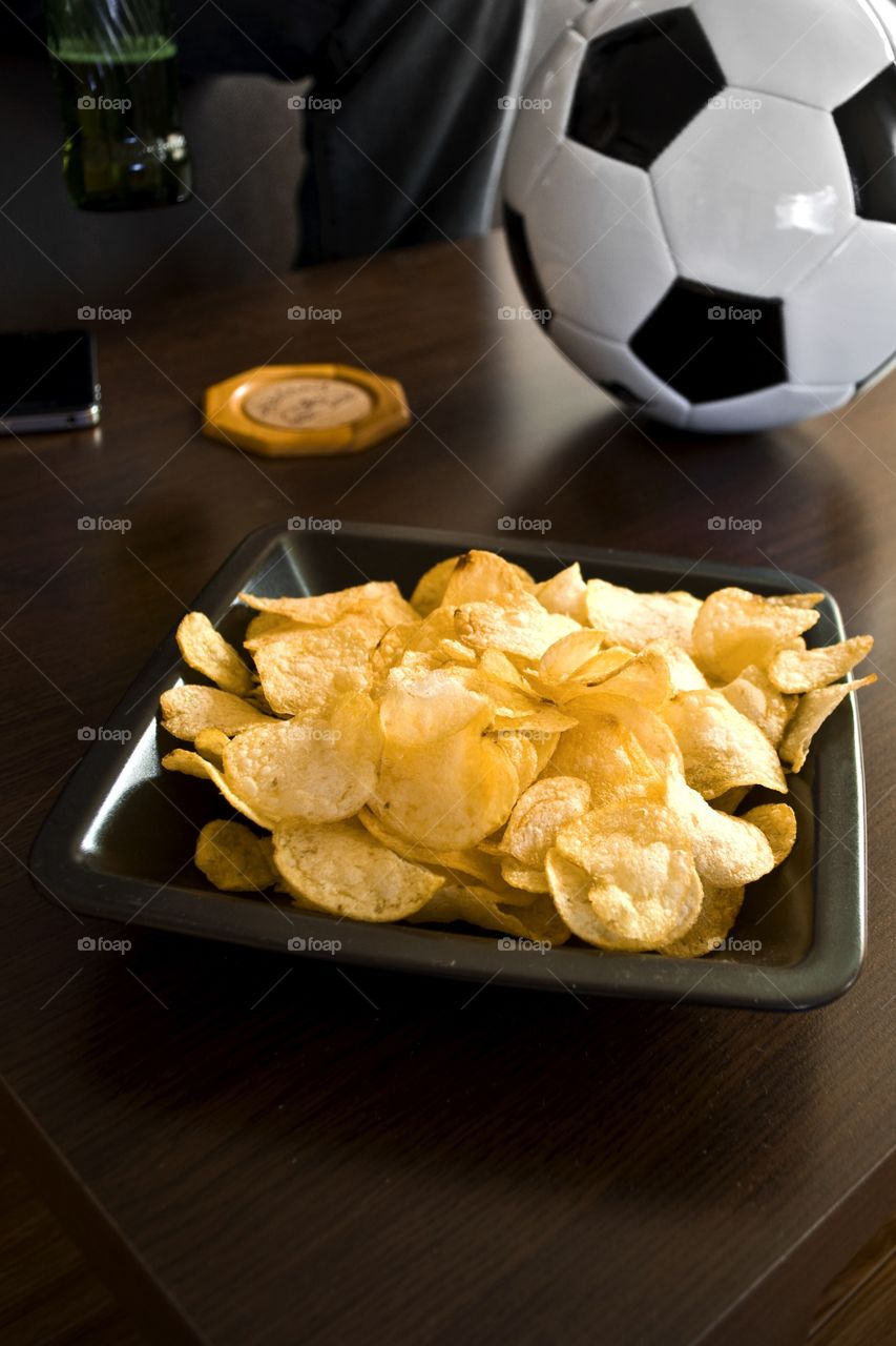 Watching the game. Having chips and beer while watching the game