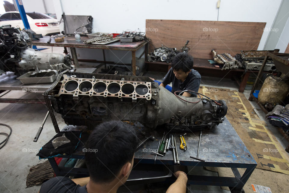 Technician fixing the engine car