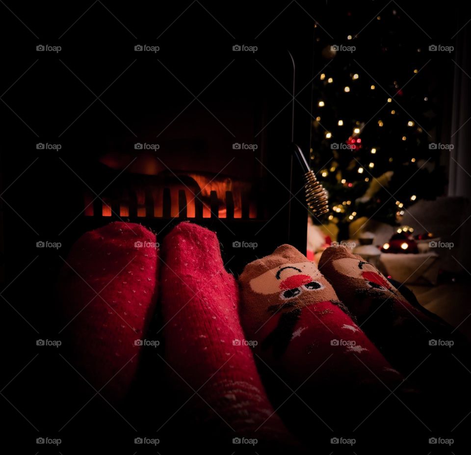 Husband and WIFE and bestfriends FEEL cosy in the front of the fire place, A Christmas day, some weeks BEFORE CHRISTMAS. In Christmas socks.