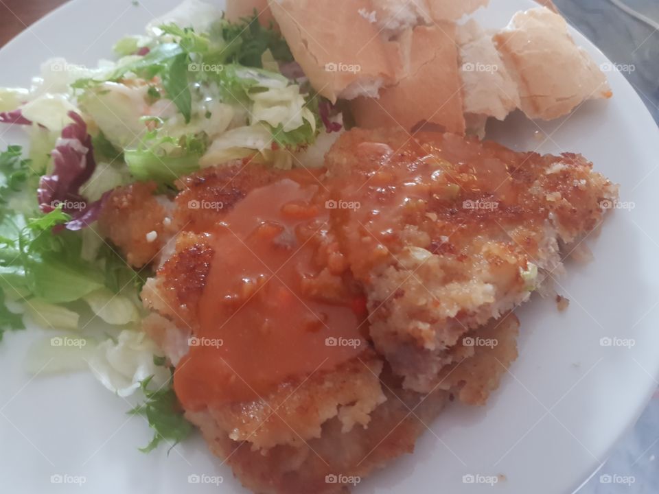 Evening meal; Schnitzel with salad, baguette and stroganoff sauce.  delicious.