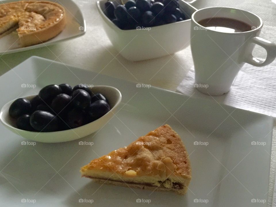 Bakewell tart  with coffee and grapes 