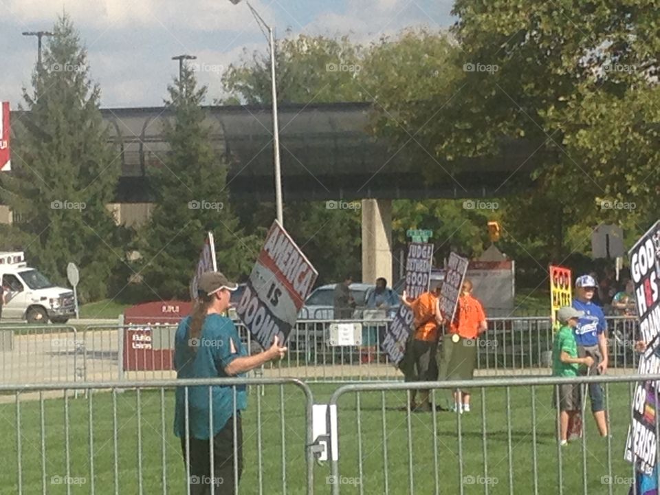 Westboro Baptist church members holding signs to protest an LGB club formed by students of IUPUI.