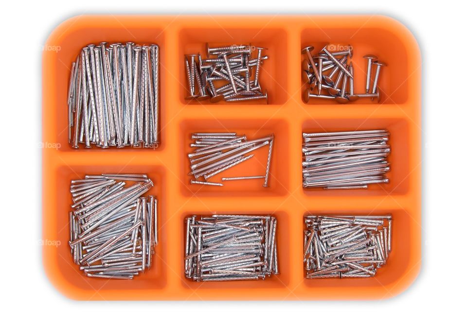 a set of nails in the toolbox isolated on white background.