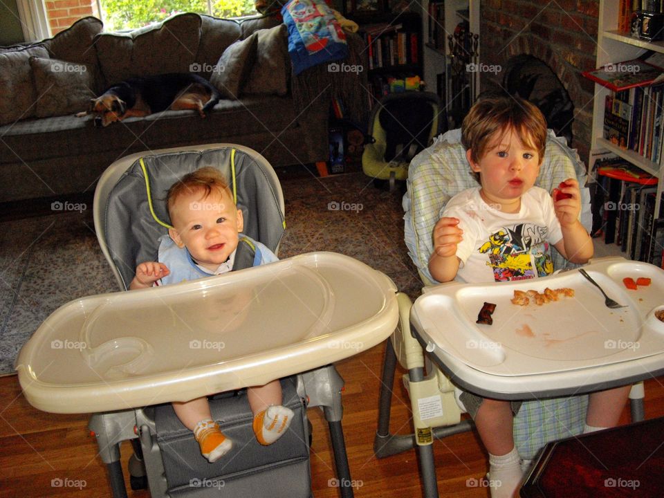 Young Children Eating In High Chairs
