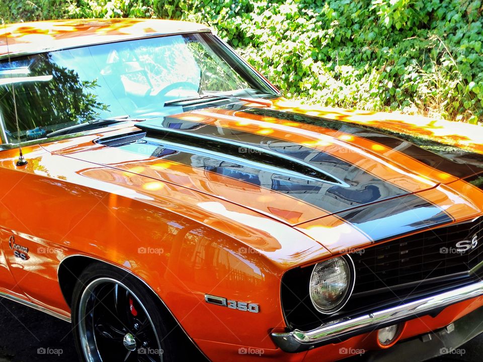 Classic Chevy Camaro Painted Orange With Racing Stripes