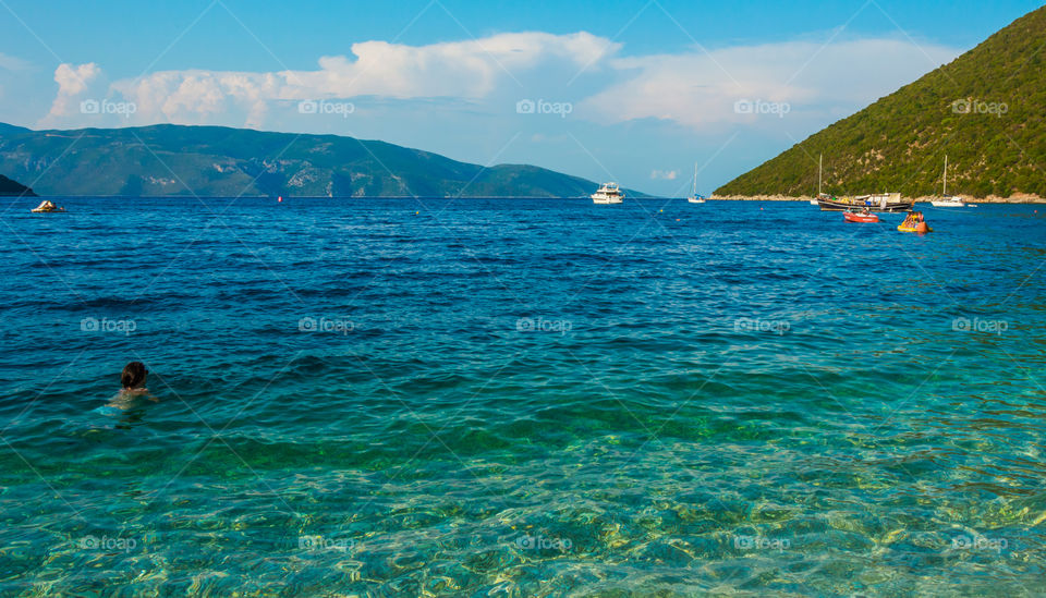 Person swimming in antisamos beach