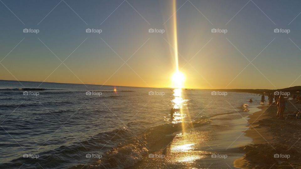 Tourist at beach during sunset