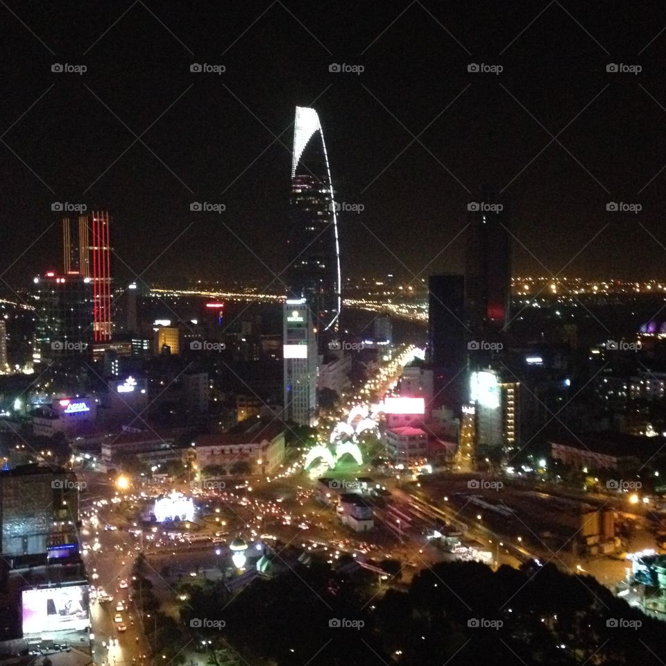 Ho Chi Minh City by Night. Vietnam's capital by night is amazing. Enjoy the spectacular view with a cool beer while sitting on a rooftop bar.