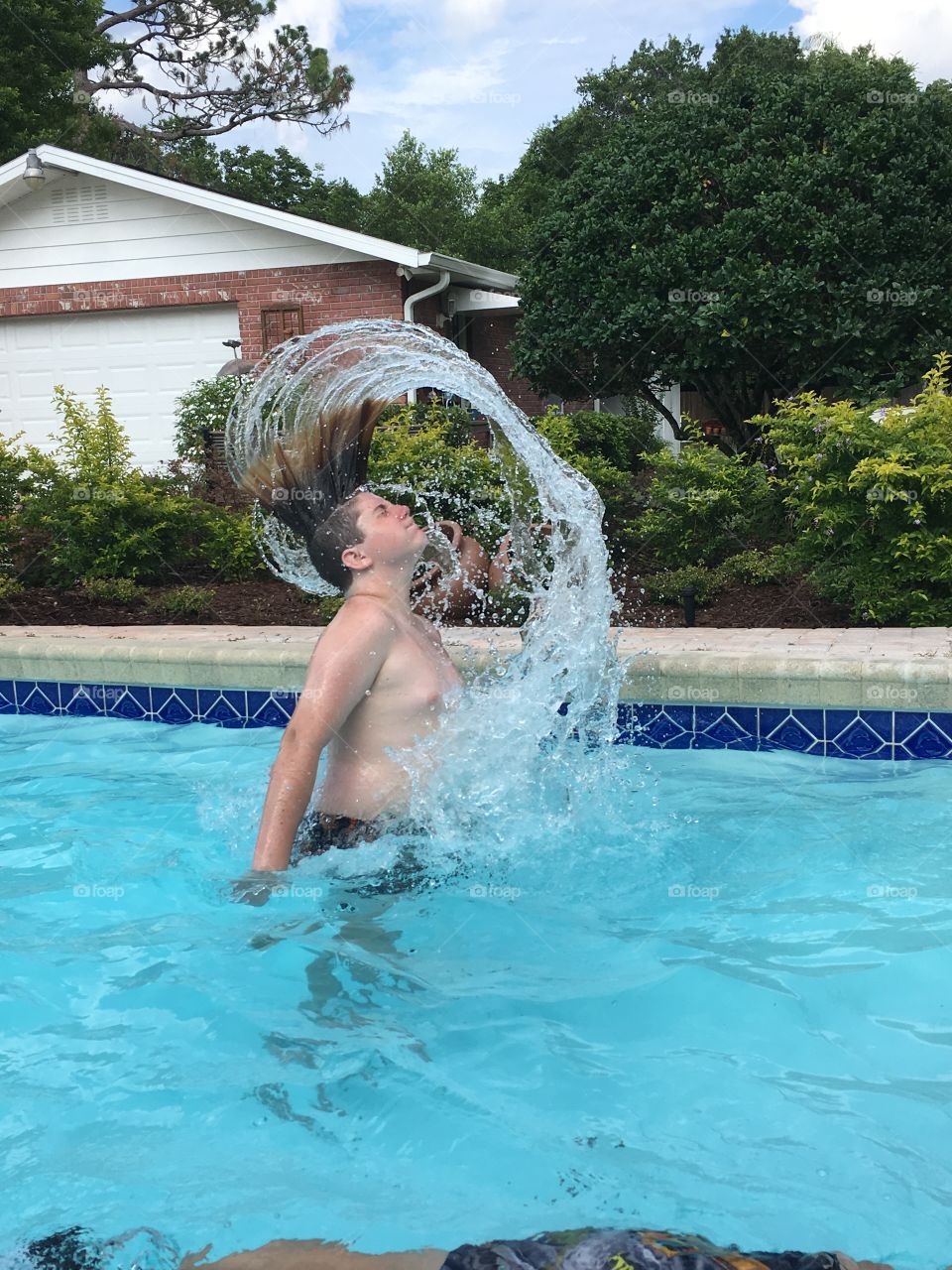 Summertime pool fun, flipping hair, water trail, splashing