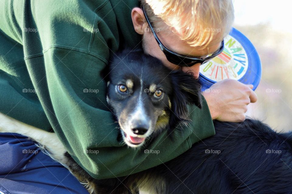 border collie hug. hugs after playing catch with the frisbee