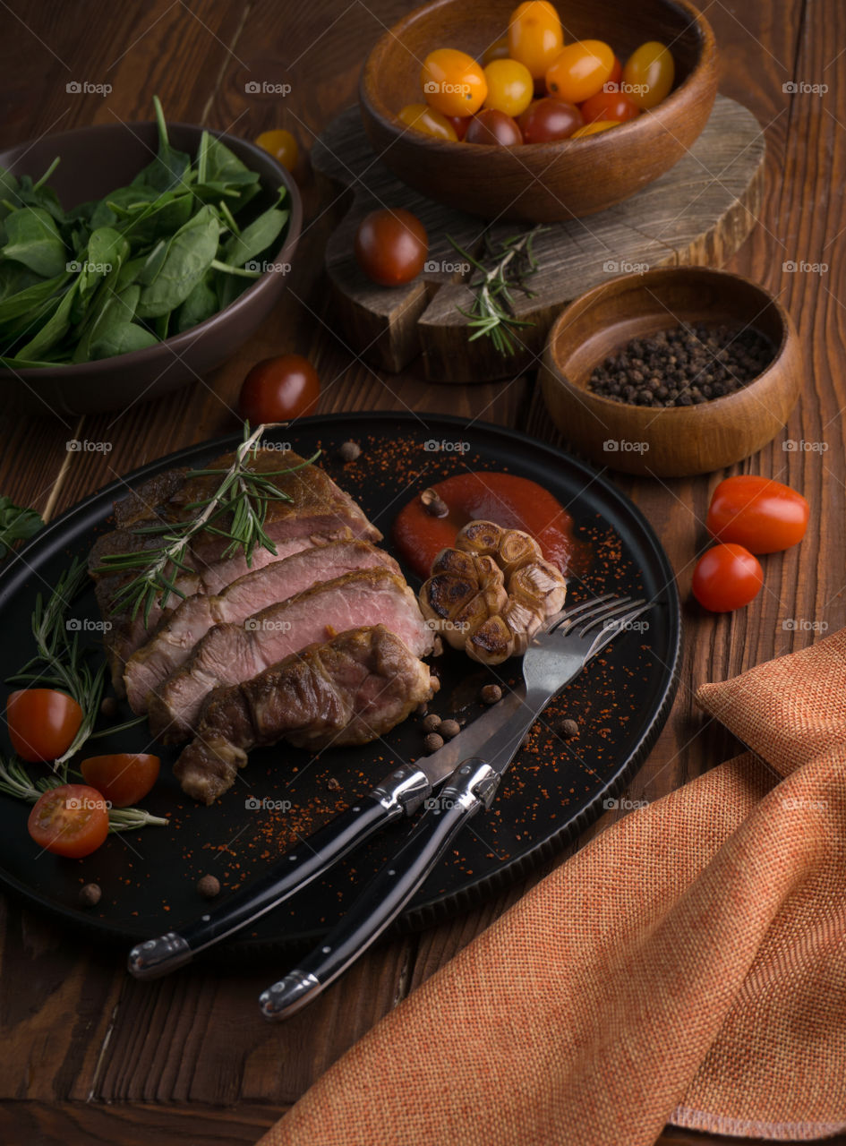 bacon steak on a dark background