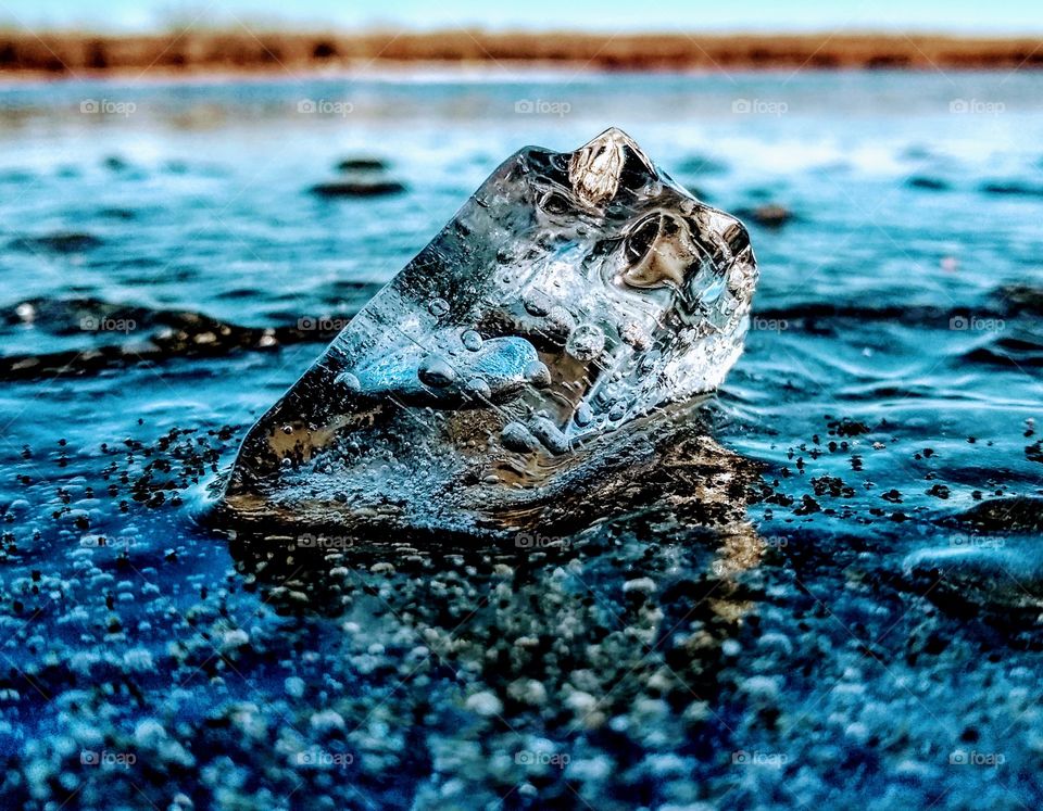 Reflected frozen ice chunk in the frozen lake. Contrasting colors "Frozen Planet"