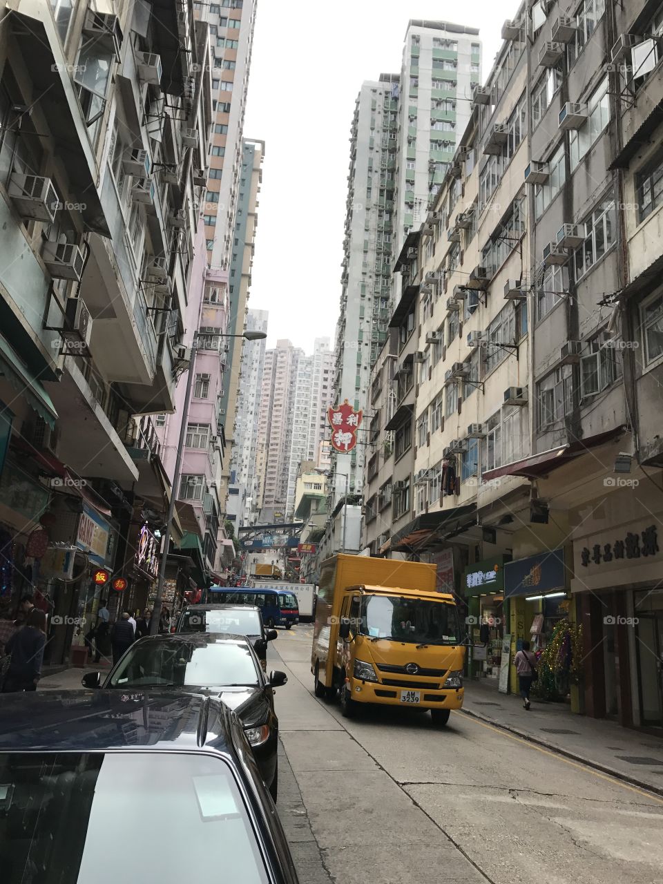 Street view of Hong Kong, tall buildings, cars on the street 