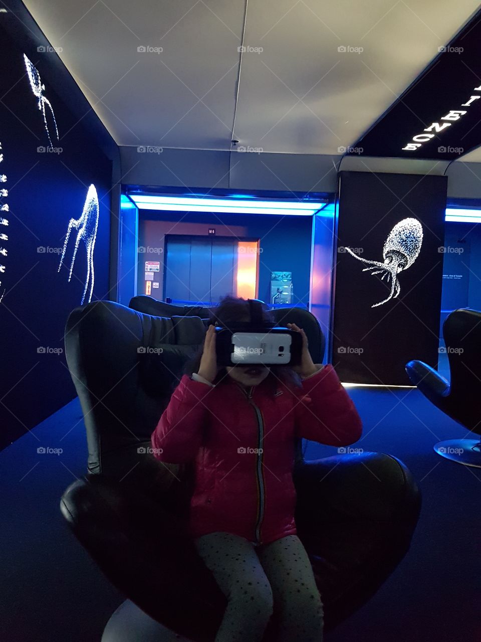 Girl having fun indoor with a virtual reality device