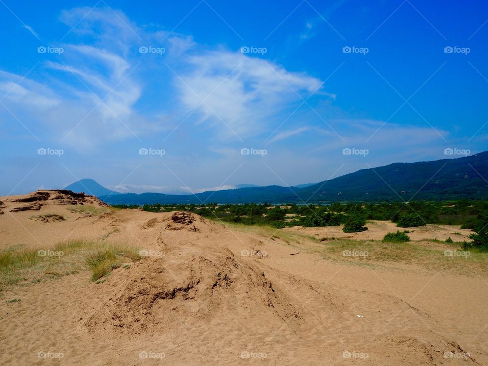 Issos beach sand dunes, lake korrission and mountains in the distance, Corfu, Greece