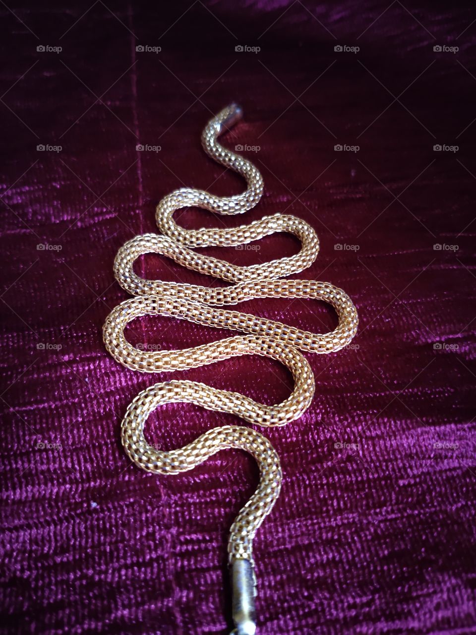 Golden chain with snake shake and design, it's an artistic chain which enhances the look of a person and gives a royal impact at every side.
