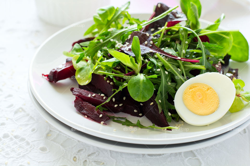 Salad with beetroot, egg, sesame and lettuce mix