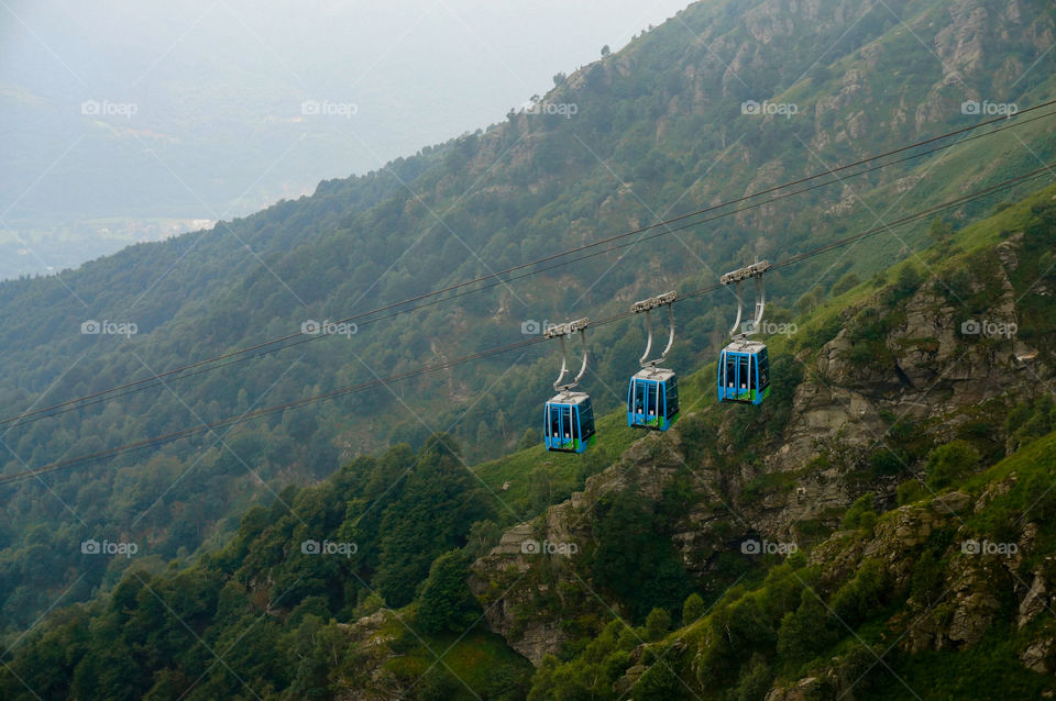 Cable car cabins move through the mountains