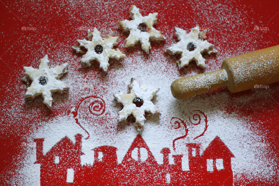 Christmas home made cookies and houses illustration of powdered sugar