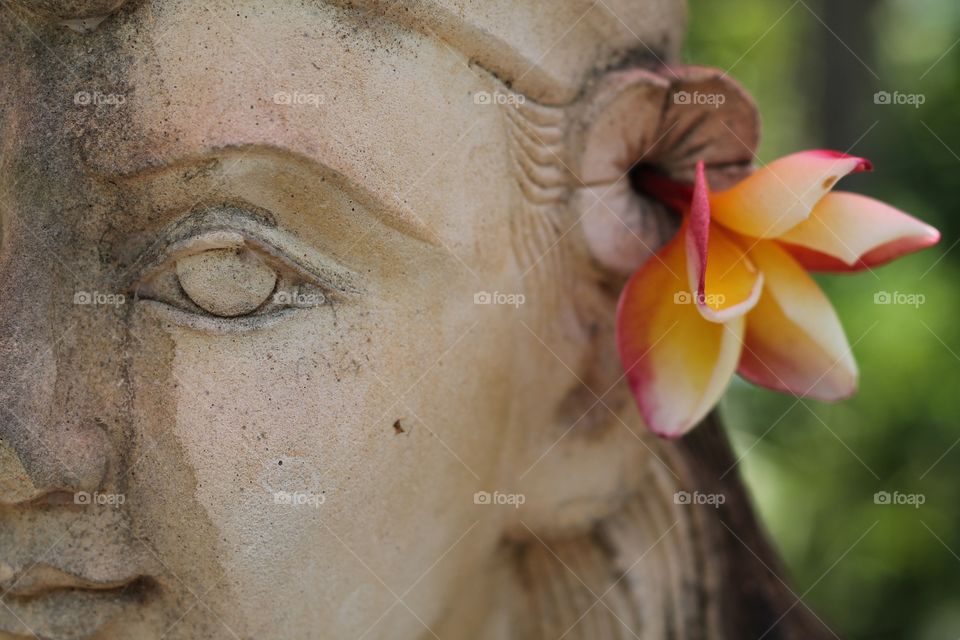 buddha flower. buddha with flower in ear