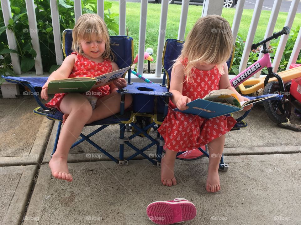 Twins reading their books. 