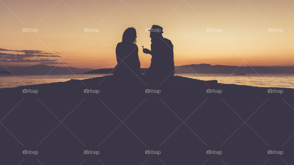 Silhouette of couple near lake