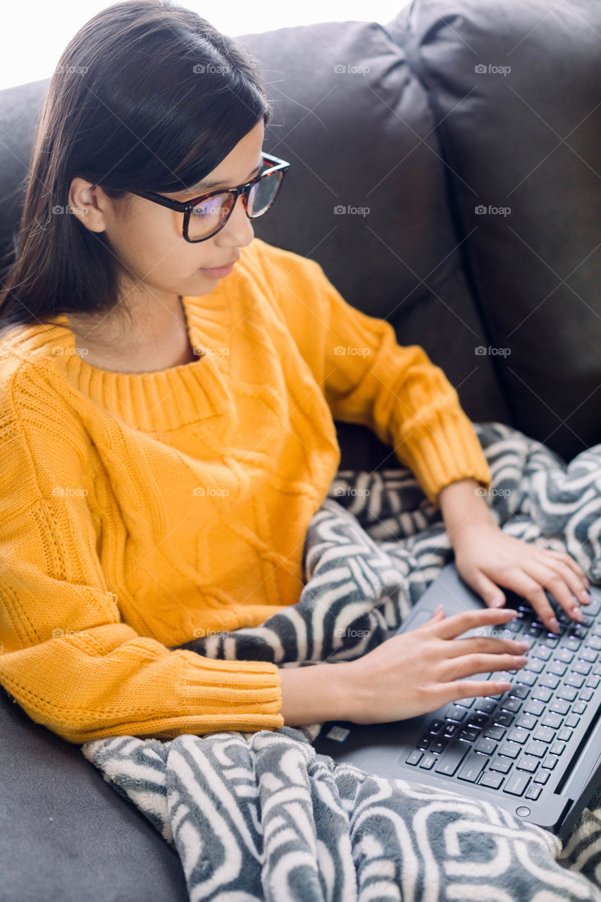 Girl typing on laptop