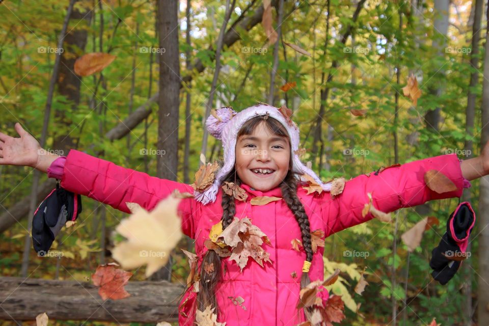 Happy girl and autumn leaves