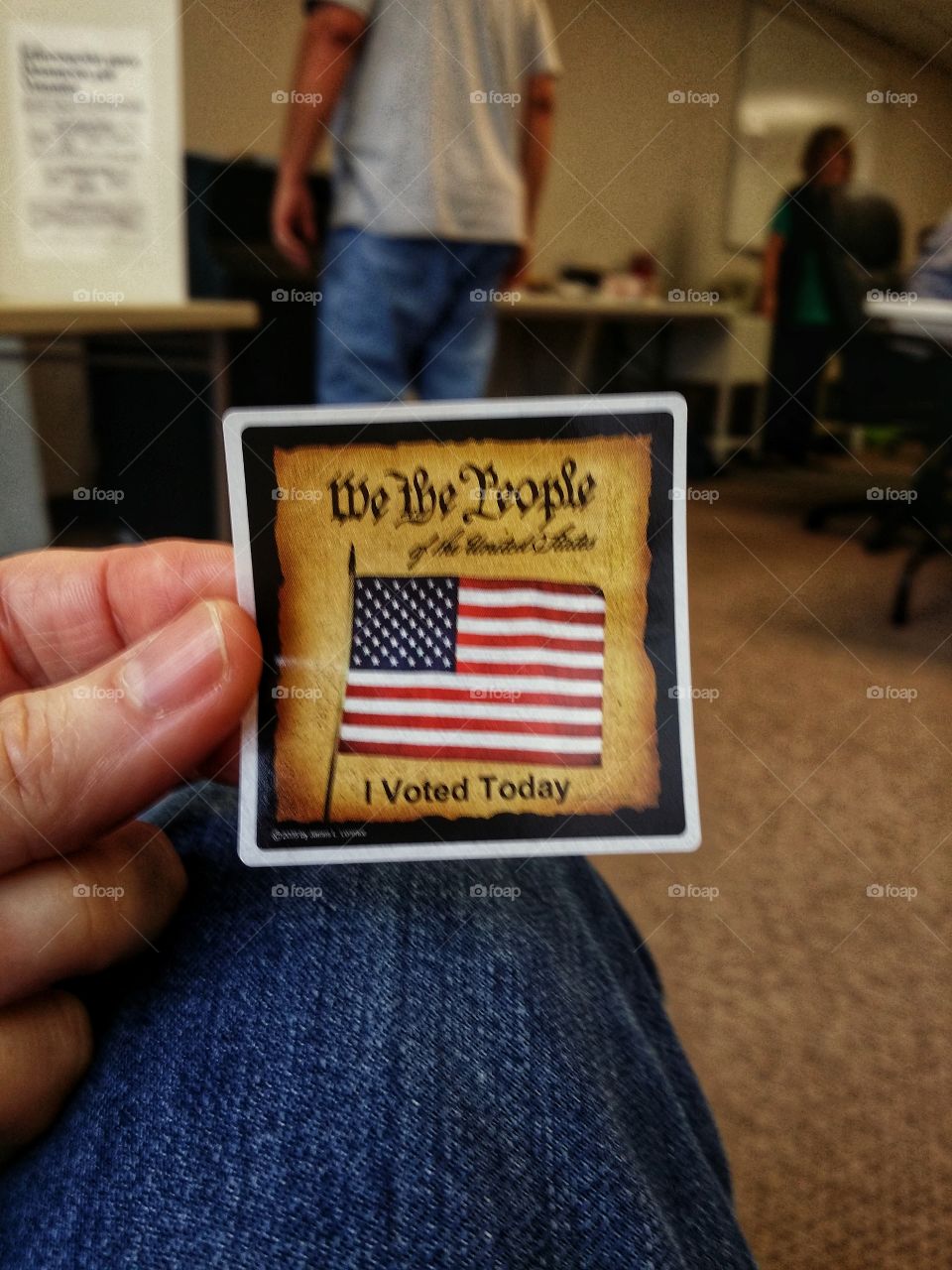 American flag on an I voted sticker at a polling place