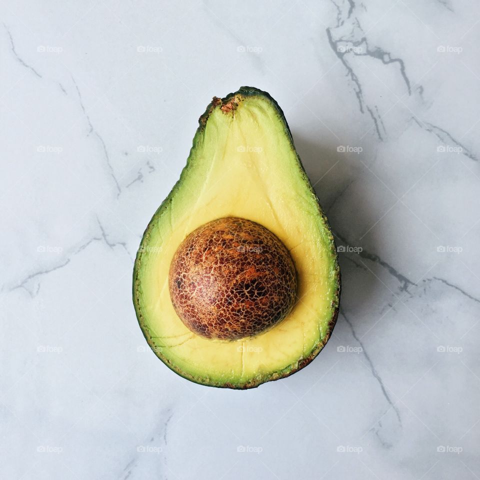Half avocado on floor