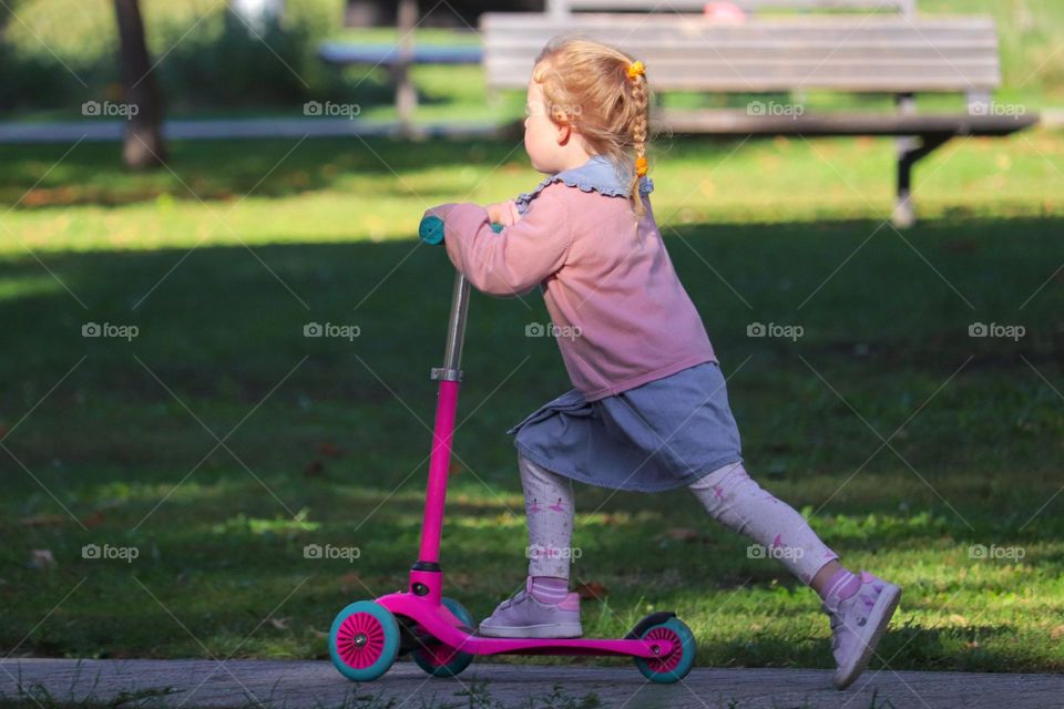 A girl at the scooter