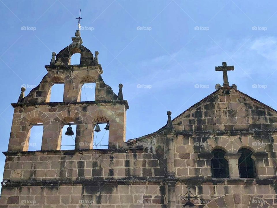 The skeletal top of a chapel towers over the tiny village of Guane, Colombia 