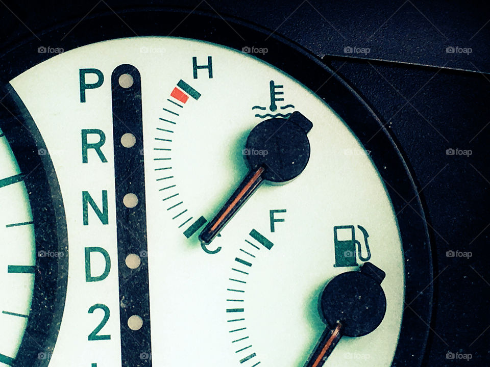 Car dashboard fuel gage and heat gauge closeup