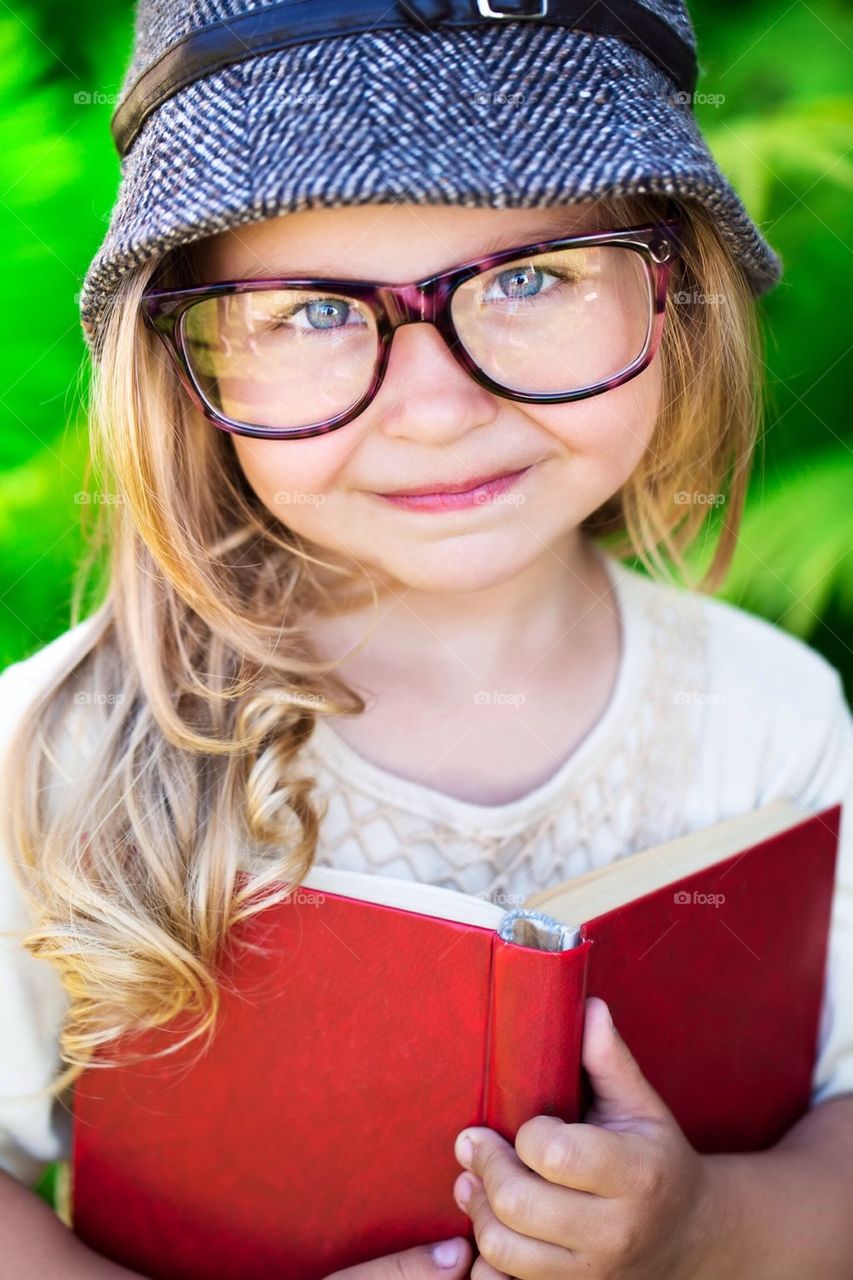 Little girl in glasses and hat