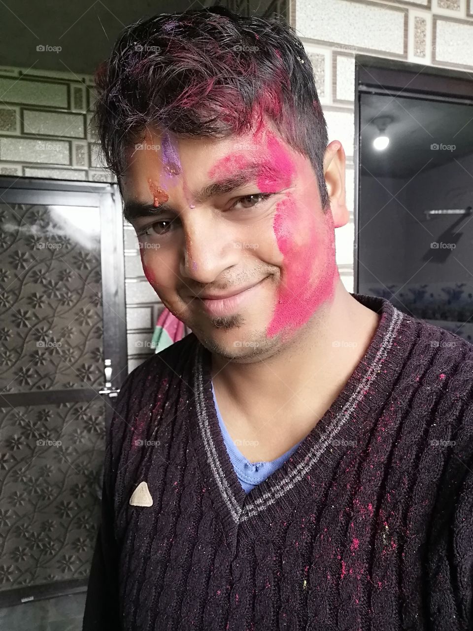 Smiling face on eve of Celebrate traditional Indian festival Holi or the festival of colors.