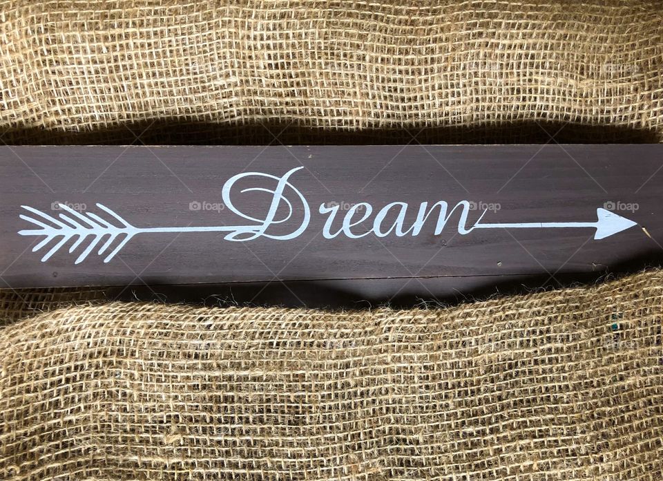 arrow dream on wooden background and burlap background
