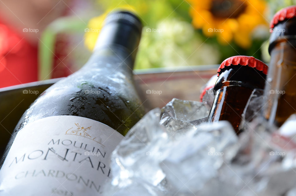 Wine and beer bottles in an ice bucket