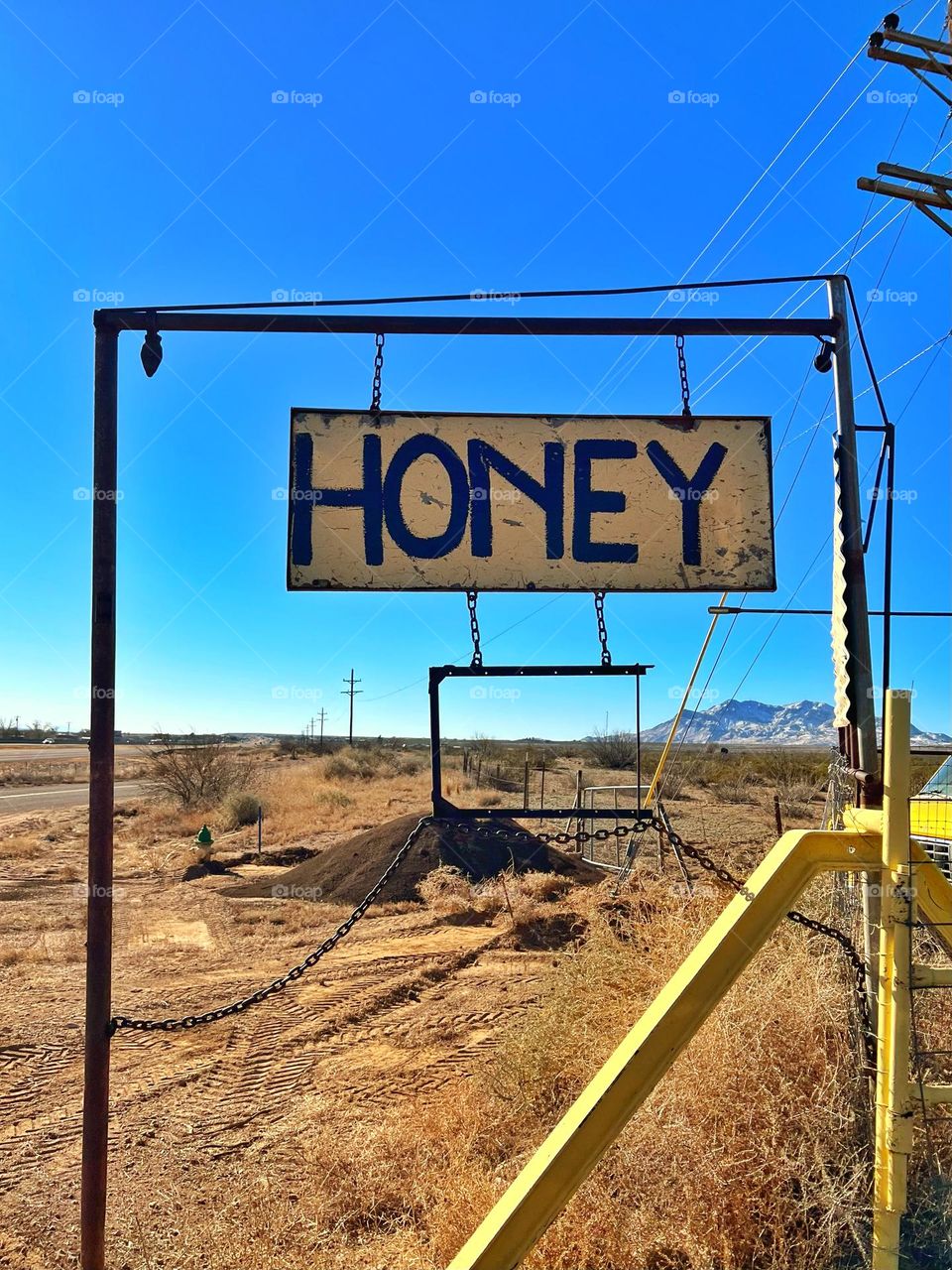 Yellow honey sign calling bee lovers on a road trip