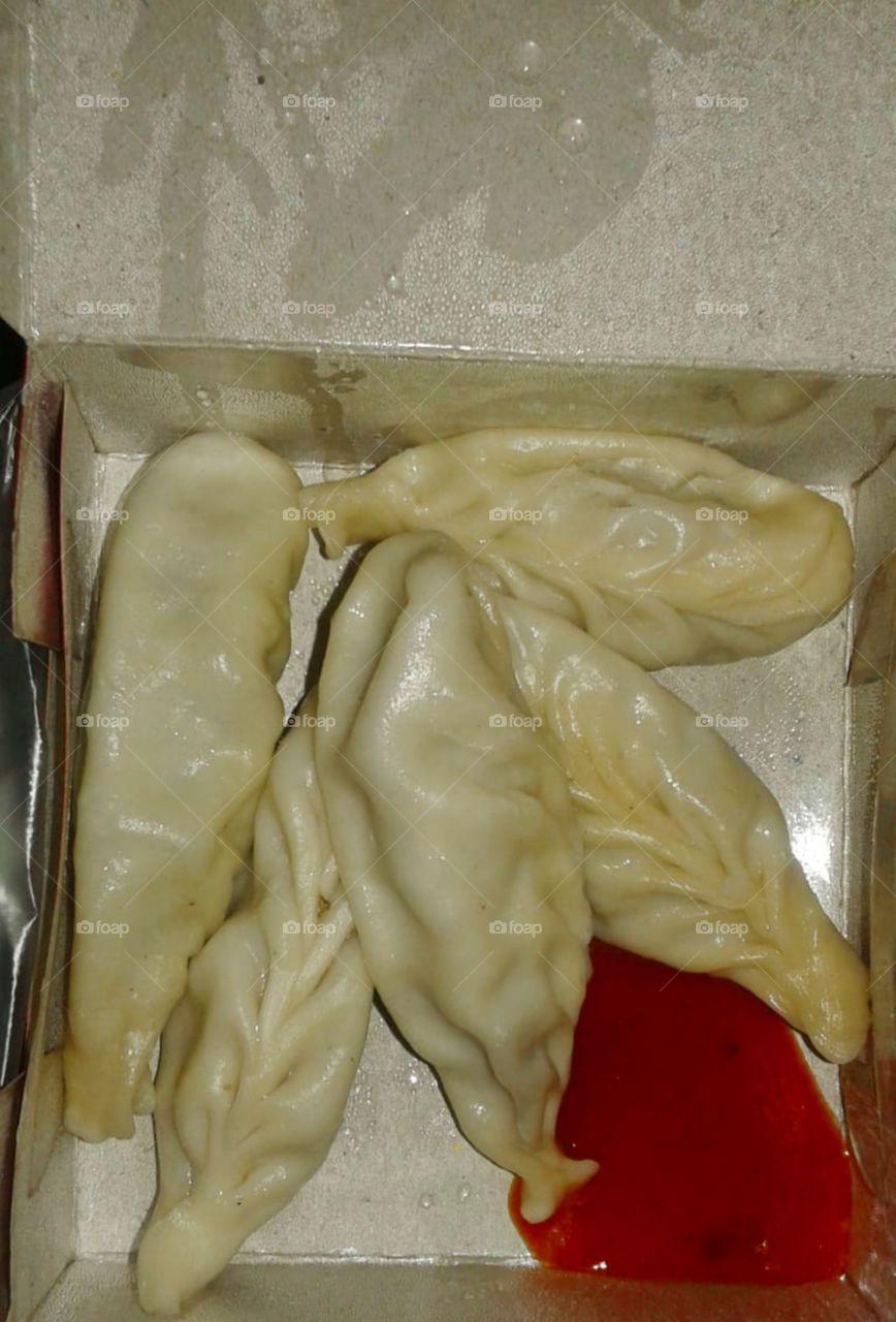 Steamed chicken momos with Tomato Ketchup
