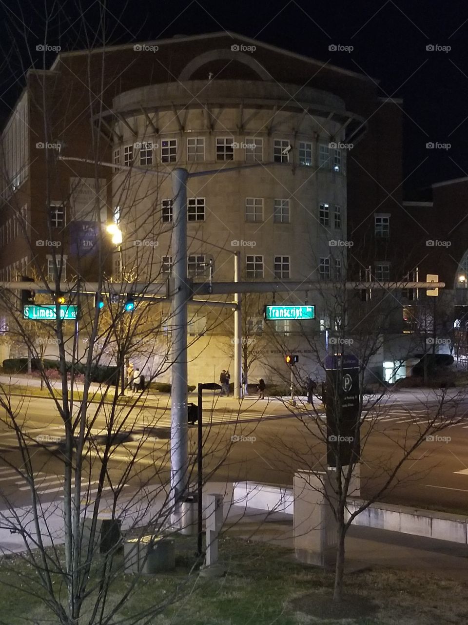 Circular building at street corner at night
