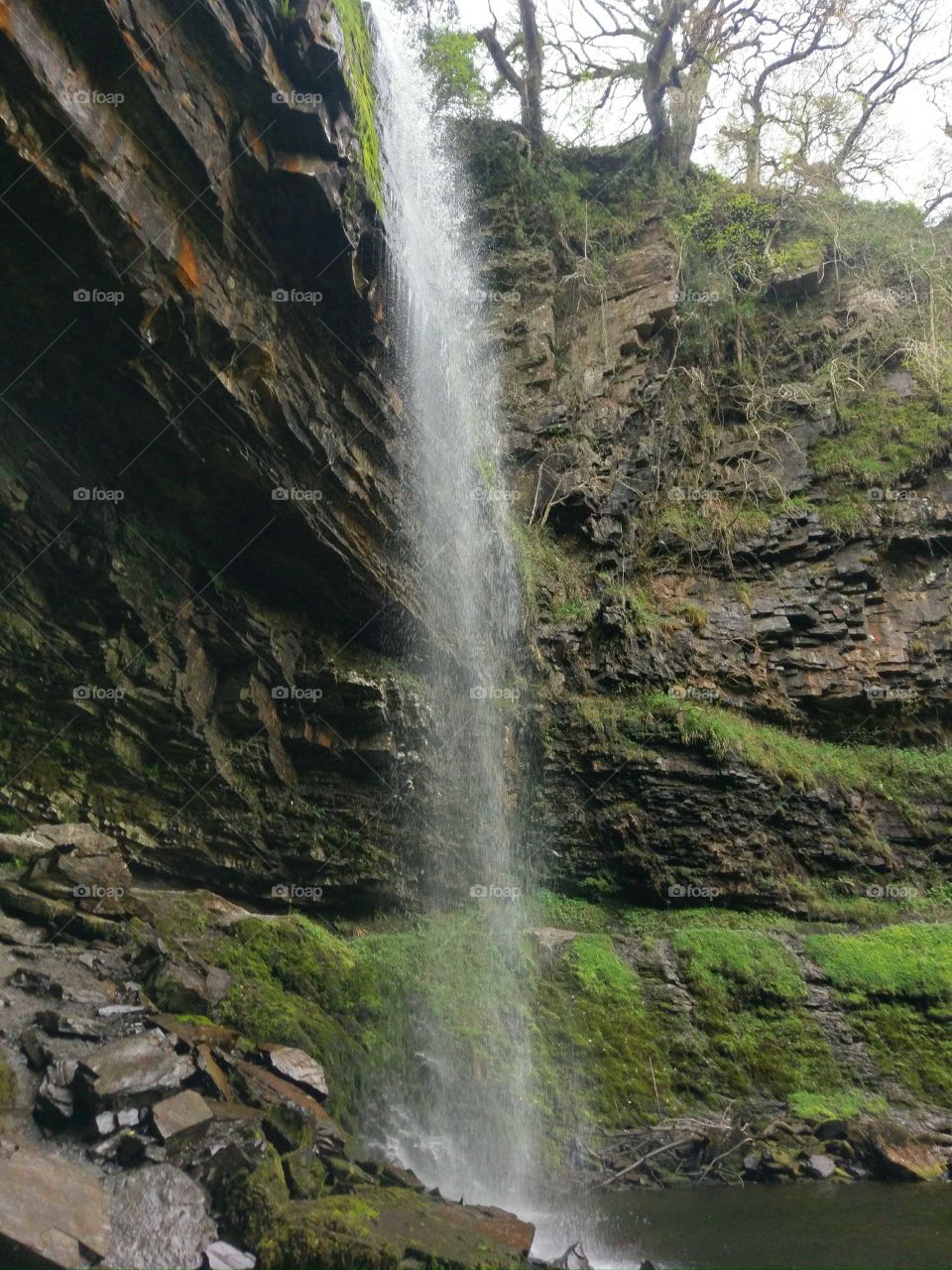 behind the waterfall of Henryd falls, south wales