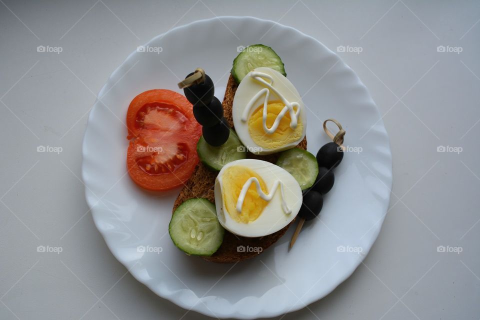 sandwiches with eggs and vegetables on a plate