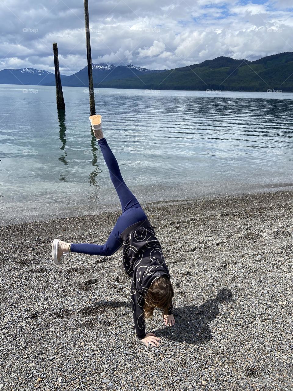 Having fun doing cartwheels on a beach in Icy Strait Point, Alaska.