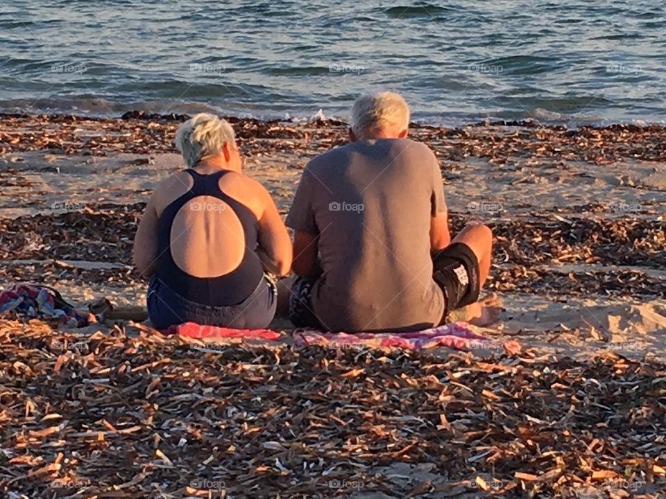 Senior couple sitting on beach
