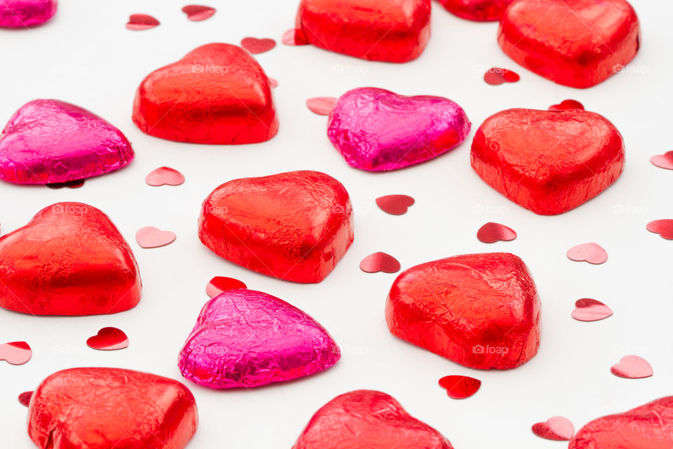 Heart shaped Valentine's Day chocolates on an isolated white background.
