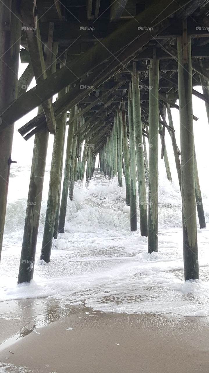 Kure Beach Pier. Rough waters at Kure Beach Pier after severe weather from the impending arrival of Hurricane Joaquin.